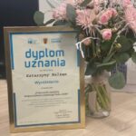 Kolorowy bukiet kwiatów z dyplomem uznania dla Katarzyny Balzam