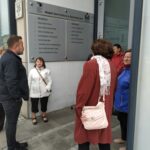 Seniorzy stoją przy Ratuszu słuchają opowieści dyrektora Zduńskowolskiego Muzeum